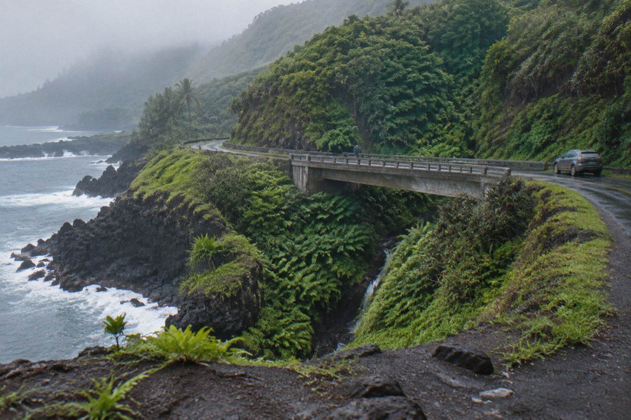Winding coastal road along green Maui cliffs above the ocean