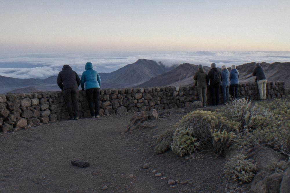 Crowd of visitors watching sunrise from Haleakala summit overlook
