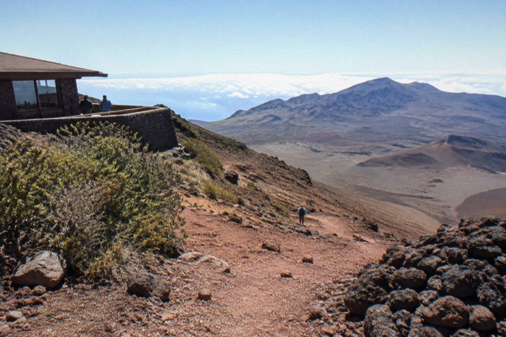 A trail descending through red cinder slopes into the Haleakala crater