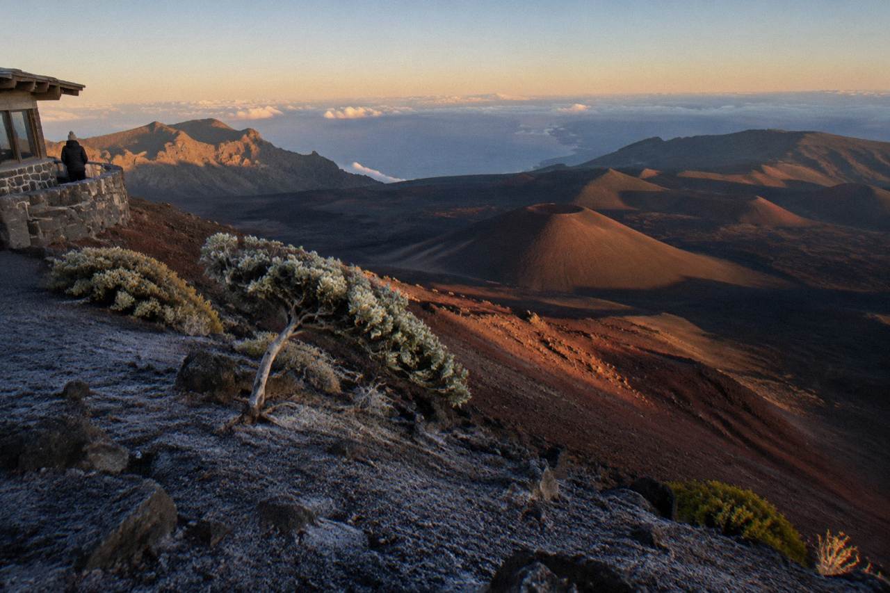 The Haleakala crater at first light, with cinder cones and shadowed slopes stretching to the horizon