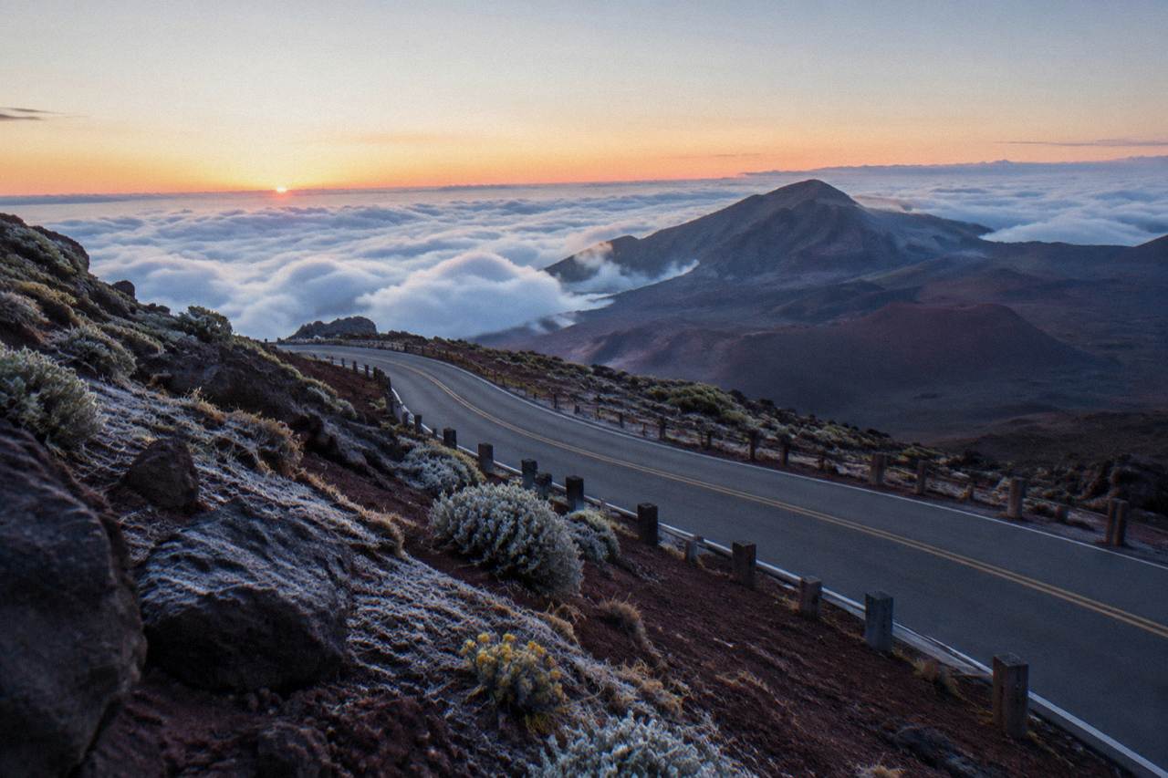 Winding paved road descending the slopes of Haleakala volcano at first light