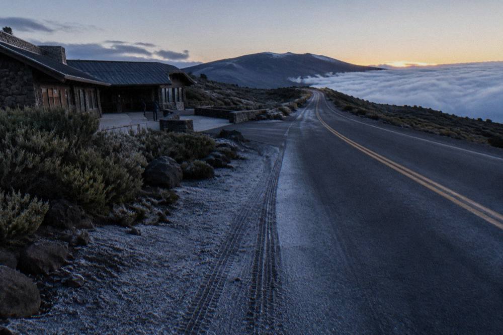 Empty crater road curving toward the Haleakala summit before dawn