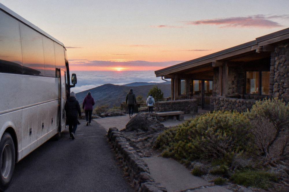 Small tour coach parked at a Haleakala overlook at first light