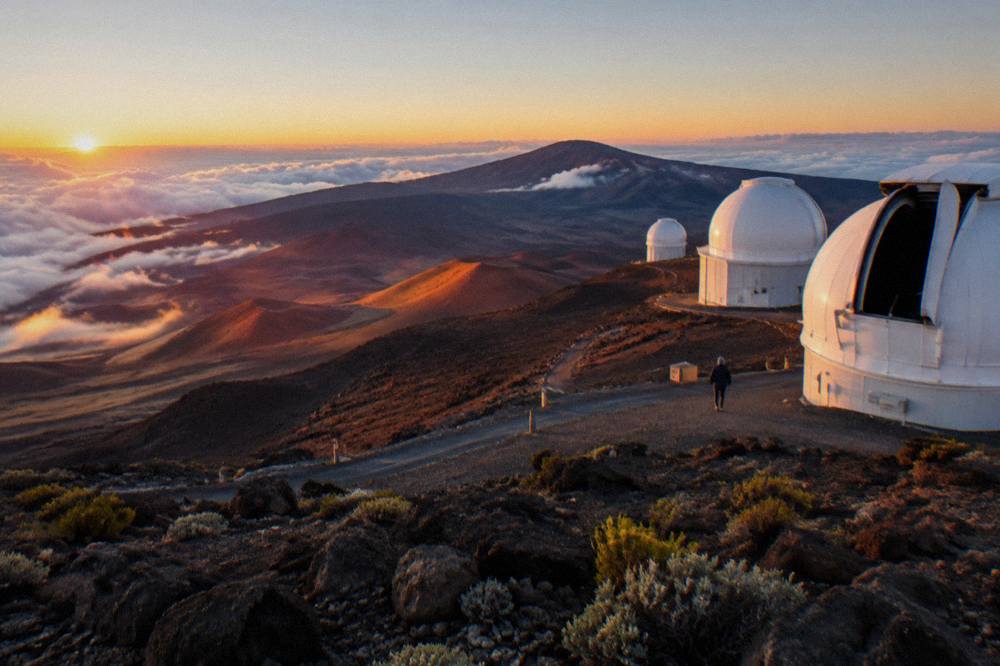 Sunrise light spreading across the Haleakala crater floor from a summit overlook