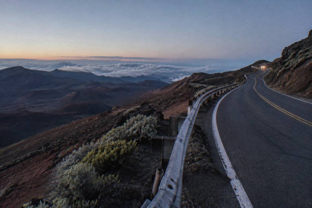 Empty summit road curving toward the Haleakala overlooks before dawn
