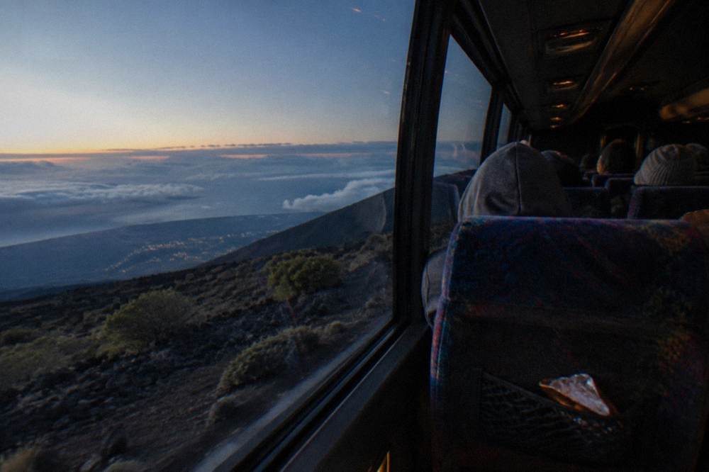 A coach interior before dawn on the switchback road up the volcano