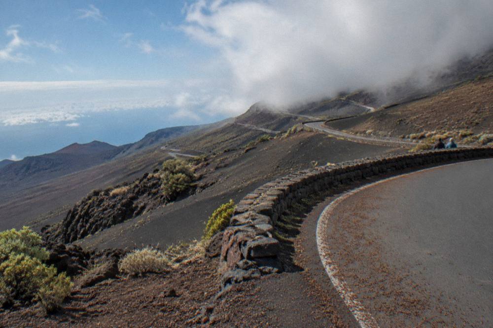 The crater road switchbacking uphill through cloud and open slopes