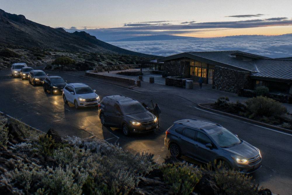 Cars parked at a Haleakala summit overlook before dawn