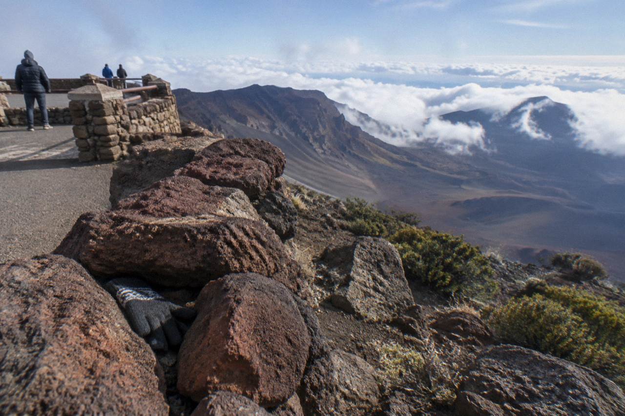 The Haleakala crater rim under a partly cloudy sky above a sea of clouds