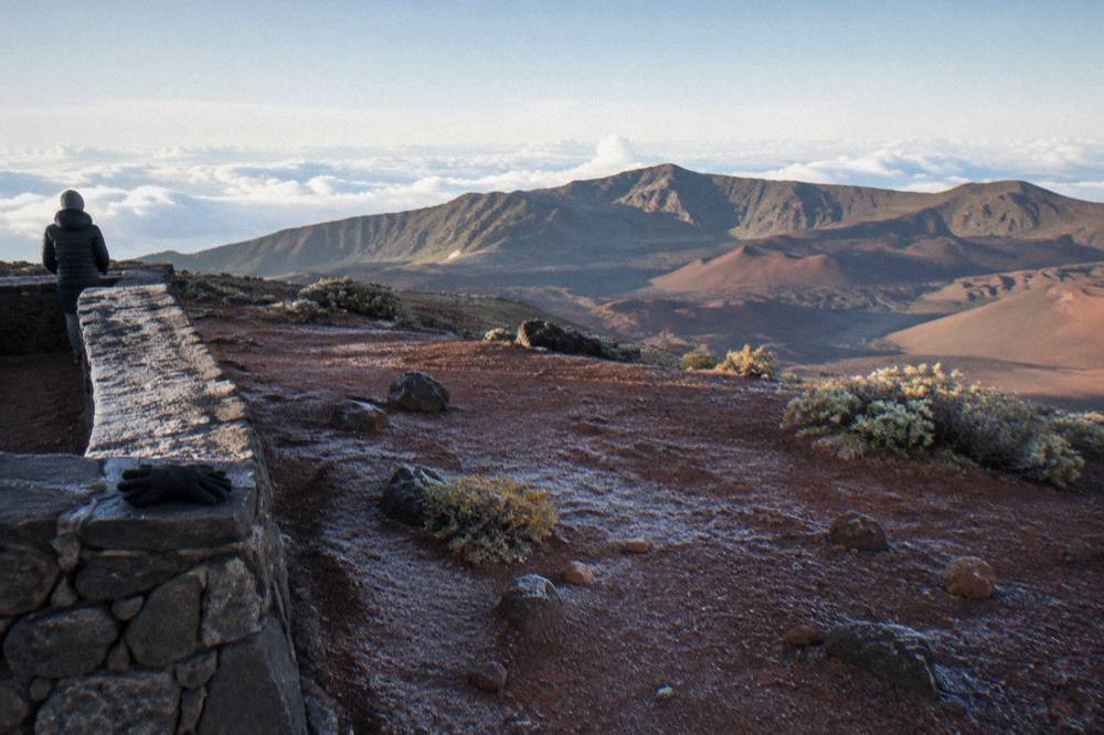 The red cinder summit viewing area at Pu'u Ula'ula under early morning light with the crater rim beyond