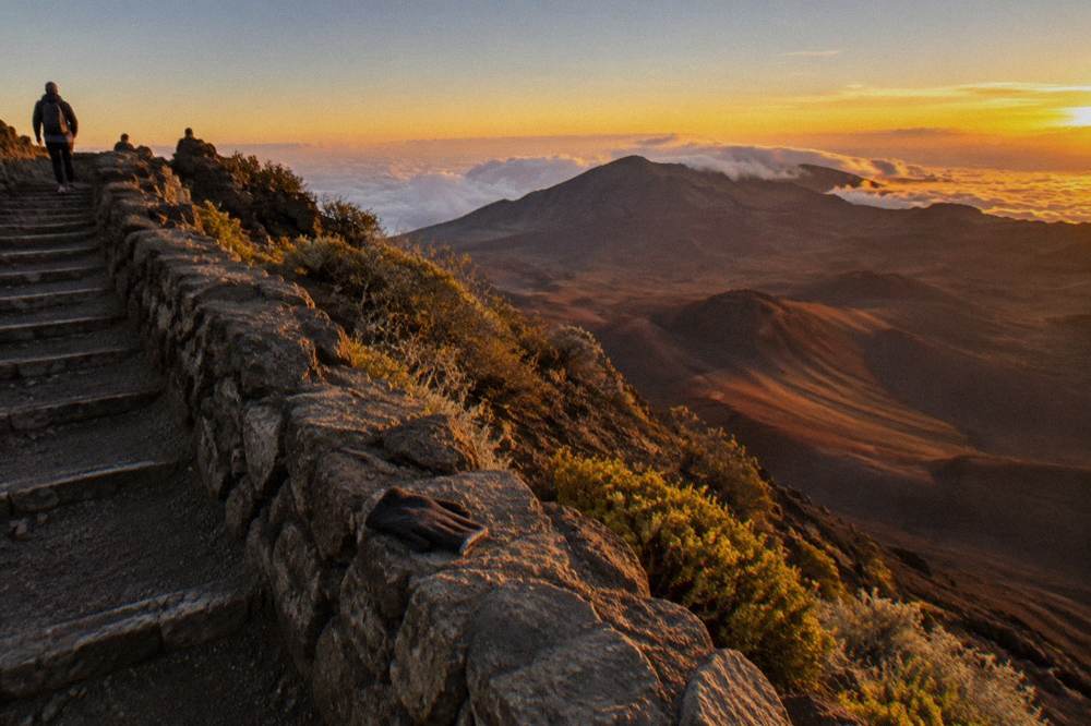 Warm sunset light filling the Haleakala crater with long shadows across the cinder slopes