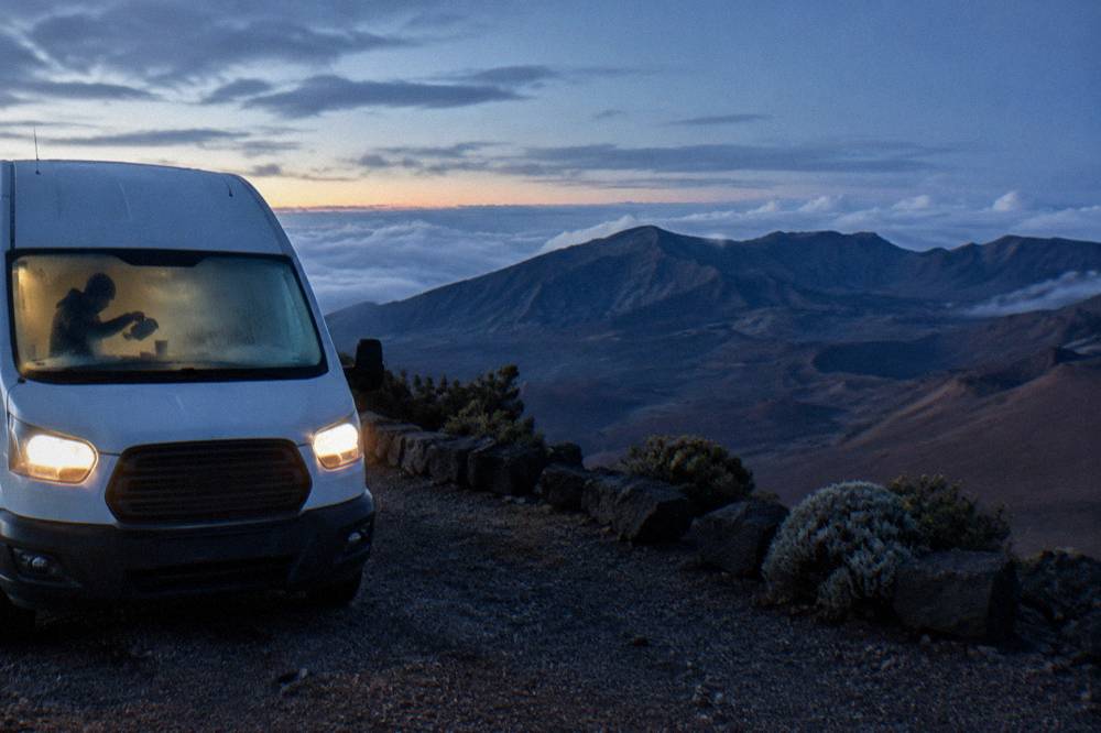 A tour van parked at a Haleakala overlook before dawn