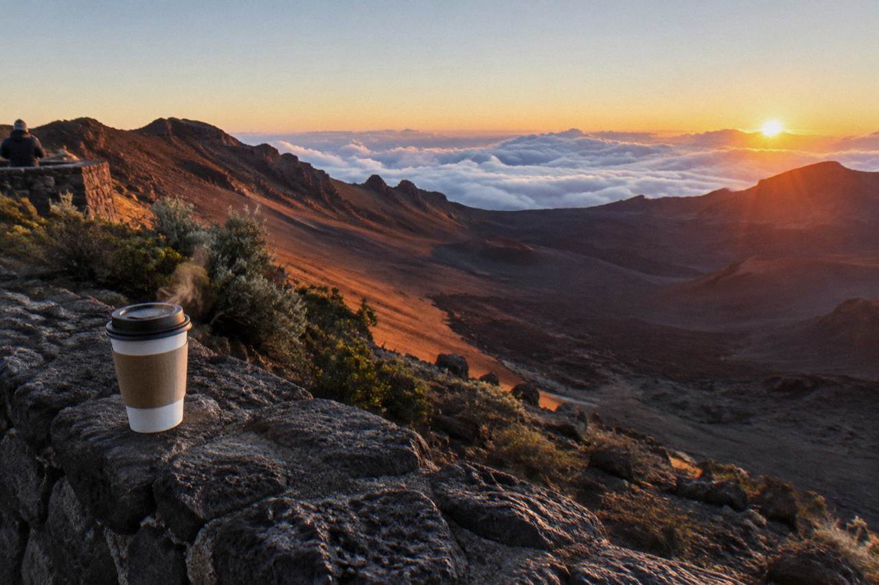 Sunrise light spreading across the Haleakala crater floor from a summit overlook