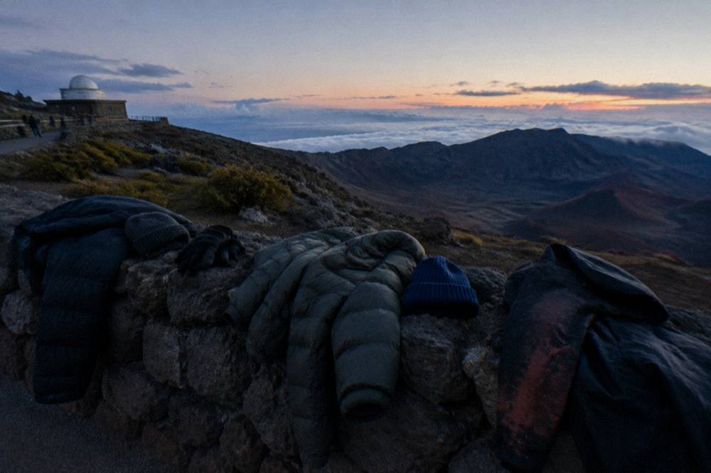 Warm jackets and gear laid out for a cold summit evening