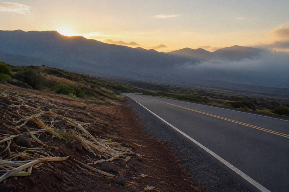 An empty highway leading from Lahaina across Maui's central valley before sunrise