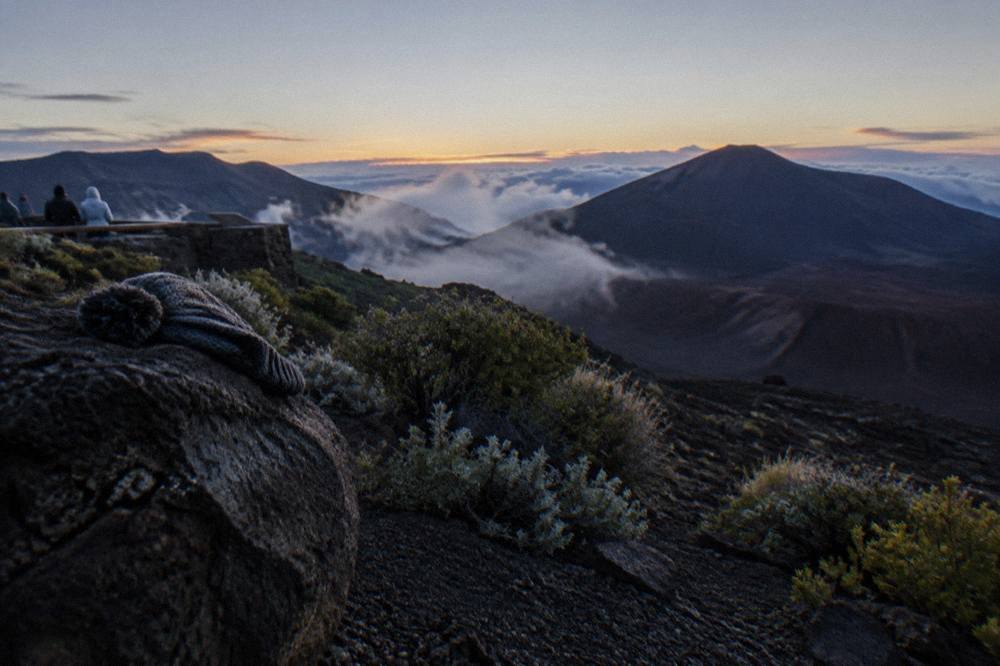 The Haleakala crater at dawn with shadowed cinder cones and pale sky