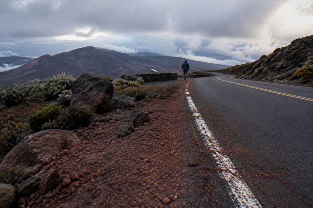 A winding paved road climbing through open volcanic slopes toward the summit
